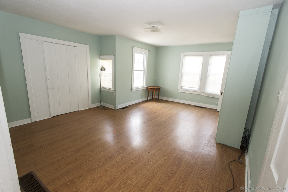 685 Kent Road New Milford, CT 06755 - Photo 25 of 34 an empty room with wooden floor and windows