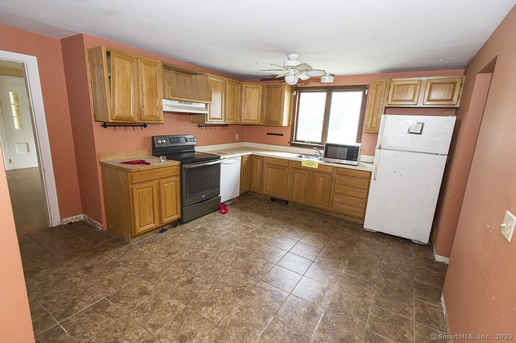 685 Kent Road New Milford, CT 06755 - Photo 26 of 34 a kitchen with a refrigerator and a stove top oven