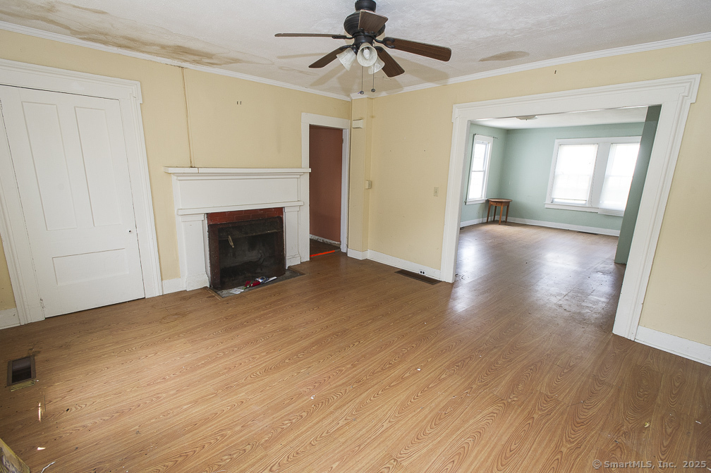 685 Kent Road New Milford, CT 06755 - Photo 27 of 34 a view of empty room with wooden floor and fireplace