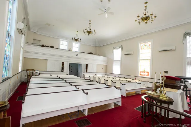 a room with pool table and windows