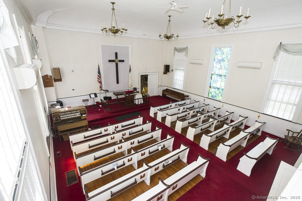 685 Kent Road New Milford, CT 06755 - Photo 9 of 34 a bed room with a bed and a chandelier