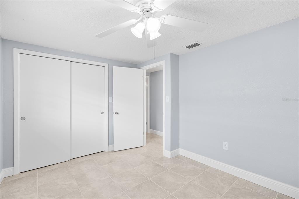 4948 Getner Street New Port Richey, FL 34652 - Photo 12 of 20 a view of an empty room and chandelier fan