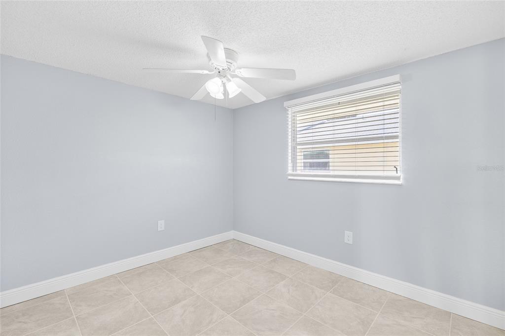 4948 Getner Street New Port Richey, FL 34652 - Photo 13 of 20 an empty room with a window and a fan