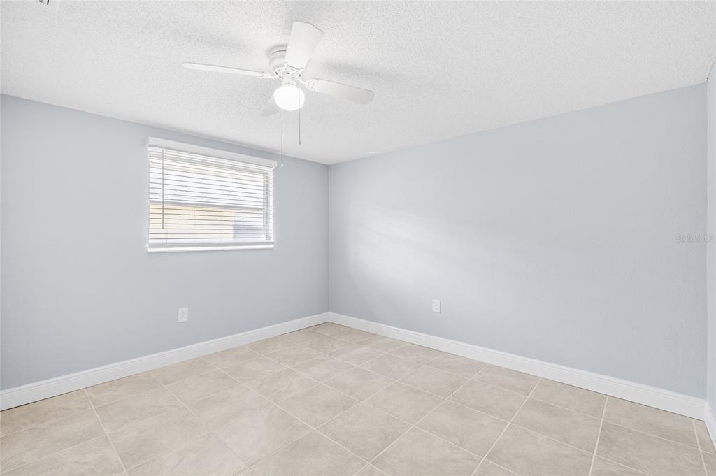 4948 Getner Street New Port Richey, FL 34652 - Photo 15 of 20 an empty room with a window and a fan