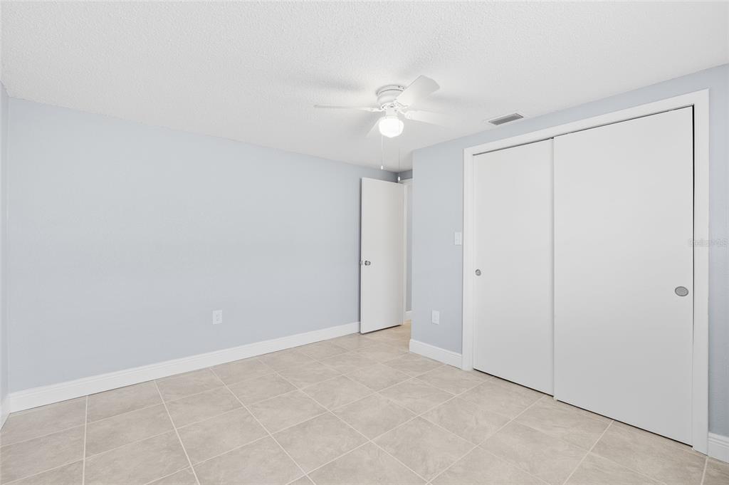 4948 Getner Street New Port Richey, FL 34652 - Photo 16 of 20 an empty room with a fan & a chandelier fan