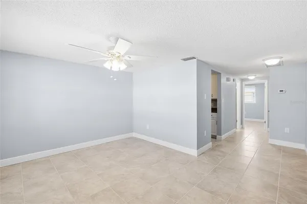 a view of an empty room with a fan