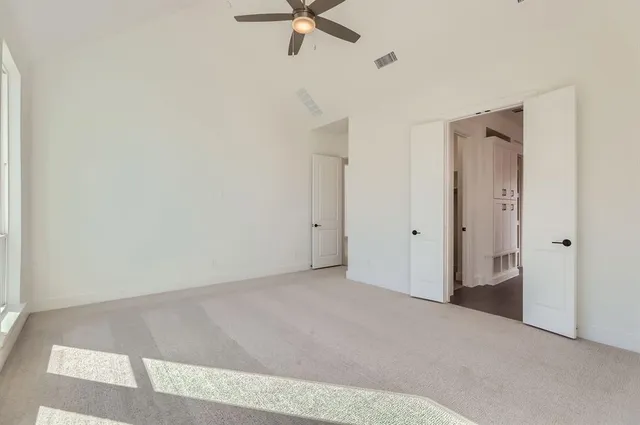 a view of a livingroom with a ceiling fan and window