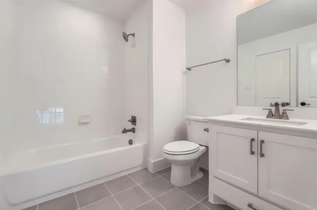 a bathroom with a sink mirror toilet and bathtub