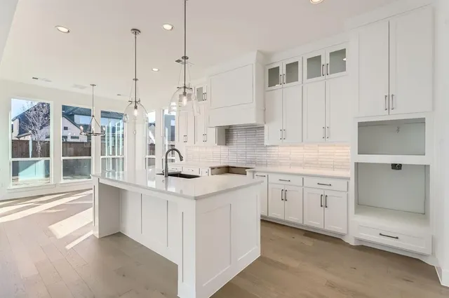 a kitchen with a sink stove and cabinets