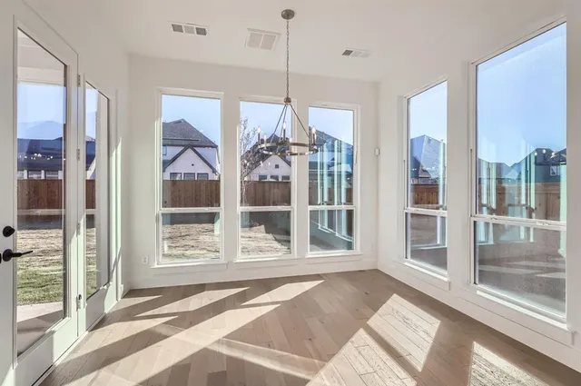 a view of a room with a large window and chandelier