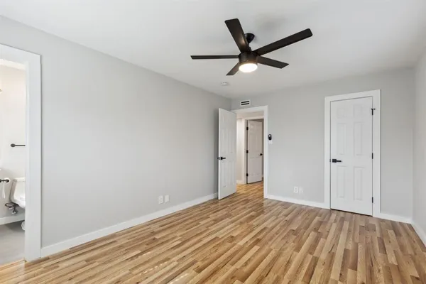 a view of a livingroom with a ceiling fan and wooden floor