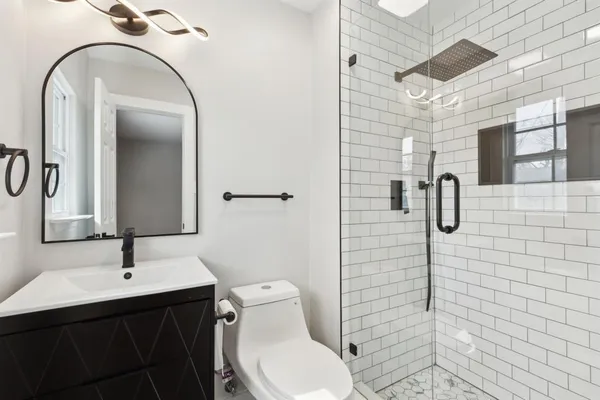 a bathroom with a sink toilet and shower