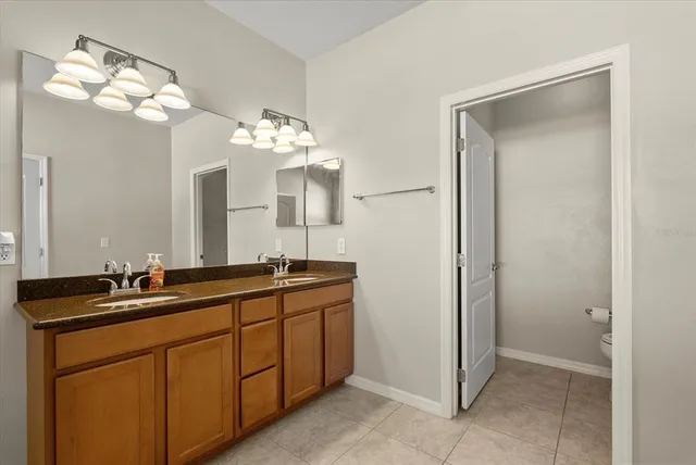 a bathroom with a double vanity sink and a mirror
