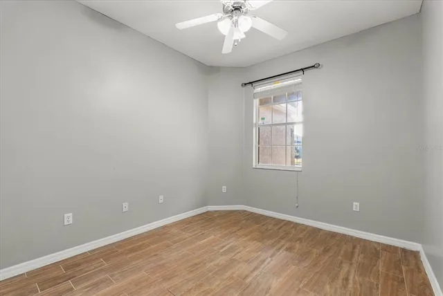 wooden floor in an empty room with a window