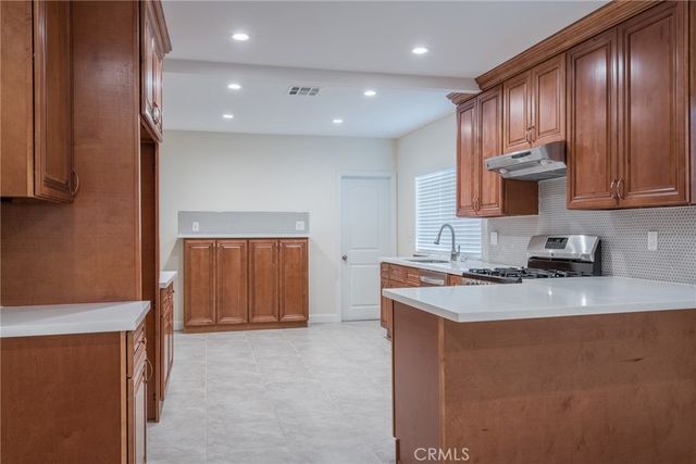 a kitchen with a stove a sink and a refrigerator