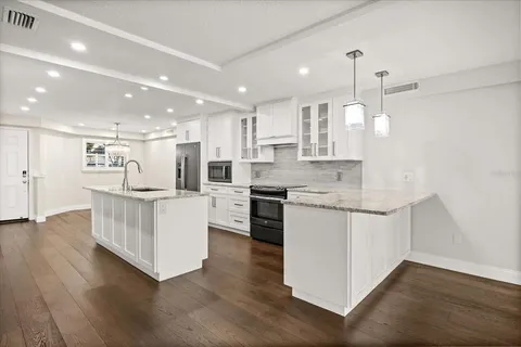 a view of empty room with wooden floor and floor to ceiling window