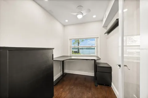 a view of a kitchen with wooden floor and a sink