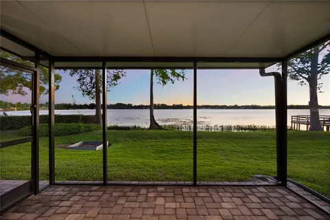 a view of a dining room with furniture a chandelier and wooden floor