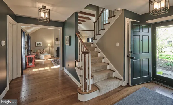 a view of entryway and hall with wooden floor
