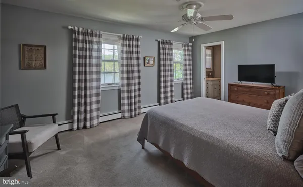 a bedroom with a bed and a television