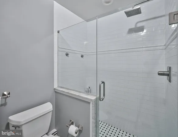a white toilet sitting next to a bathroom sink