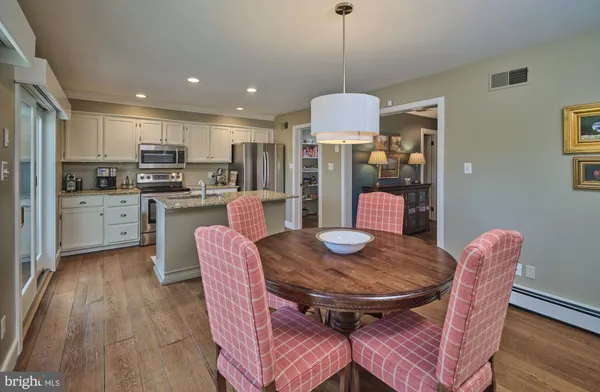 a view of a dining room with furniture wooden floor and chandelier