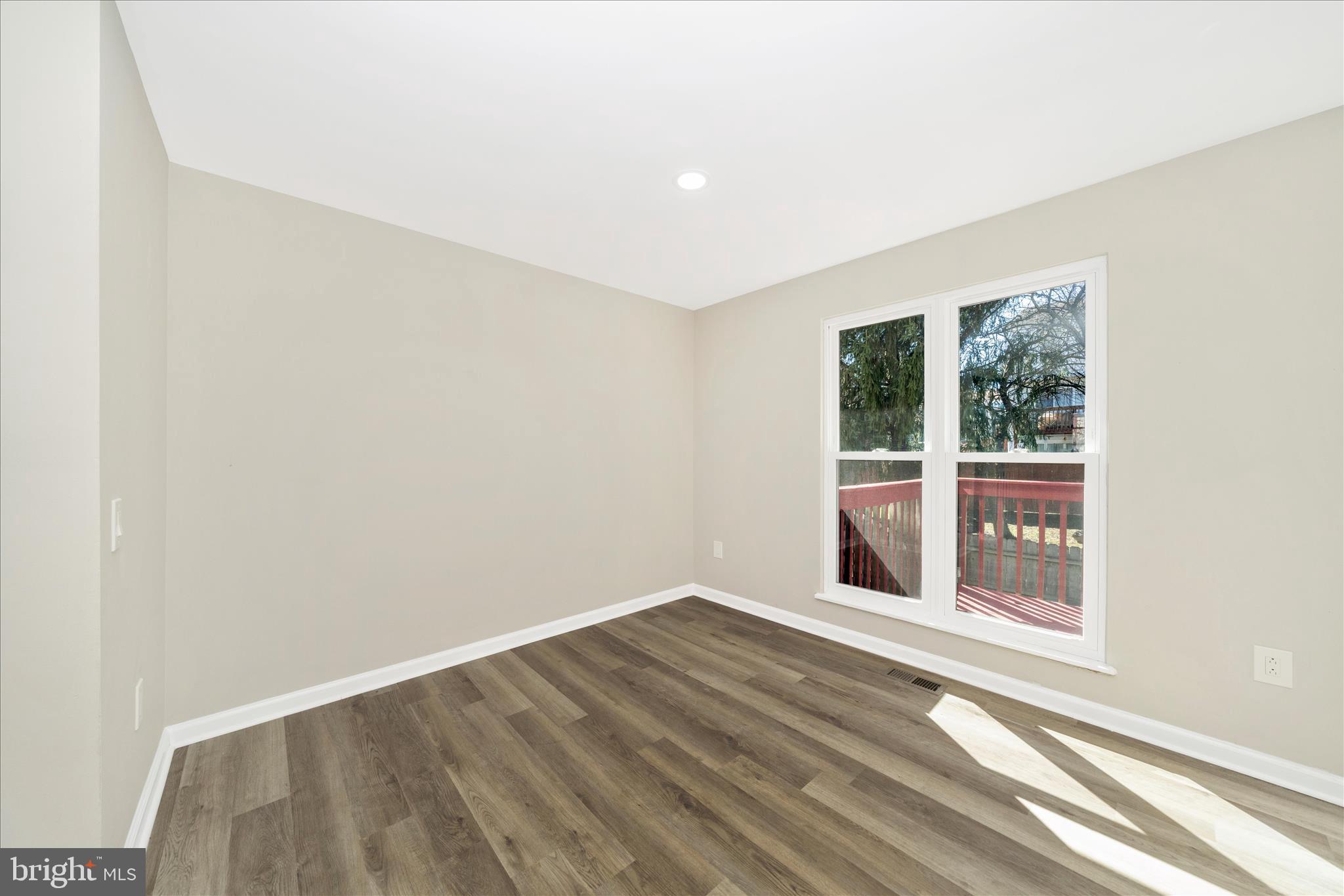 1848 Murdock Court Frederick, MD 21702 - Photo 17 of 54 an empty room with wooden floor and windows