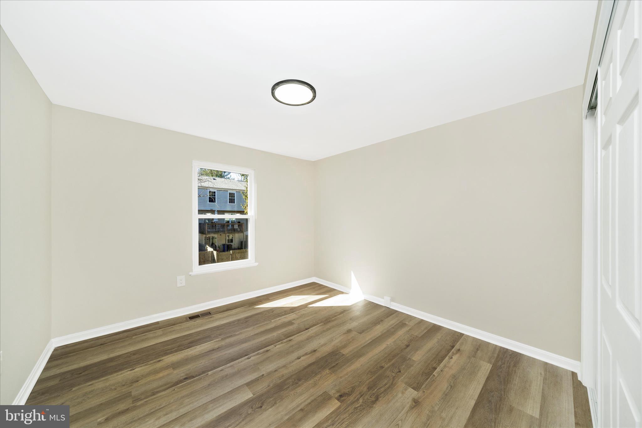 1848 Murdock Court Frederick, MD 21702 - Photo 27 of 54 a view of an empty room with wooden floor and a window