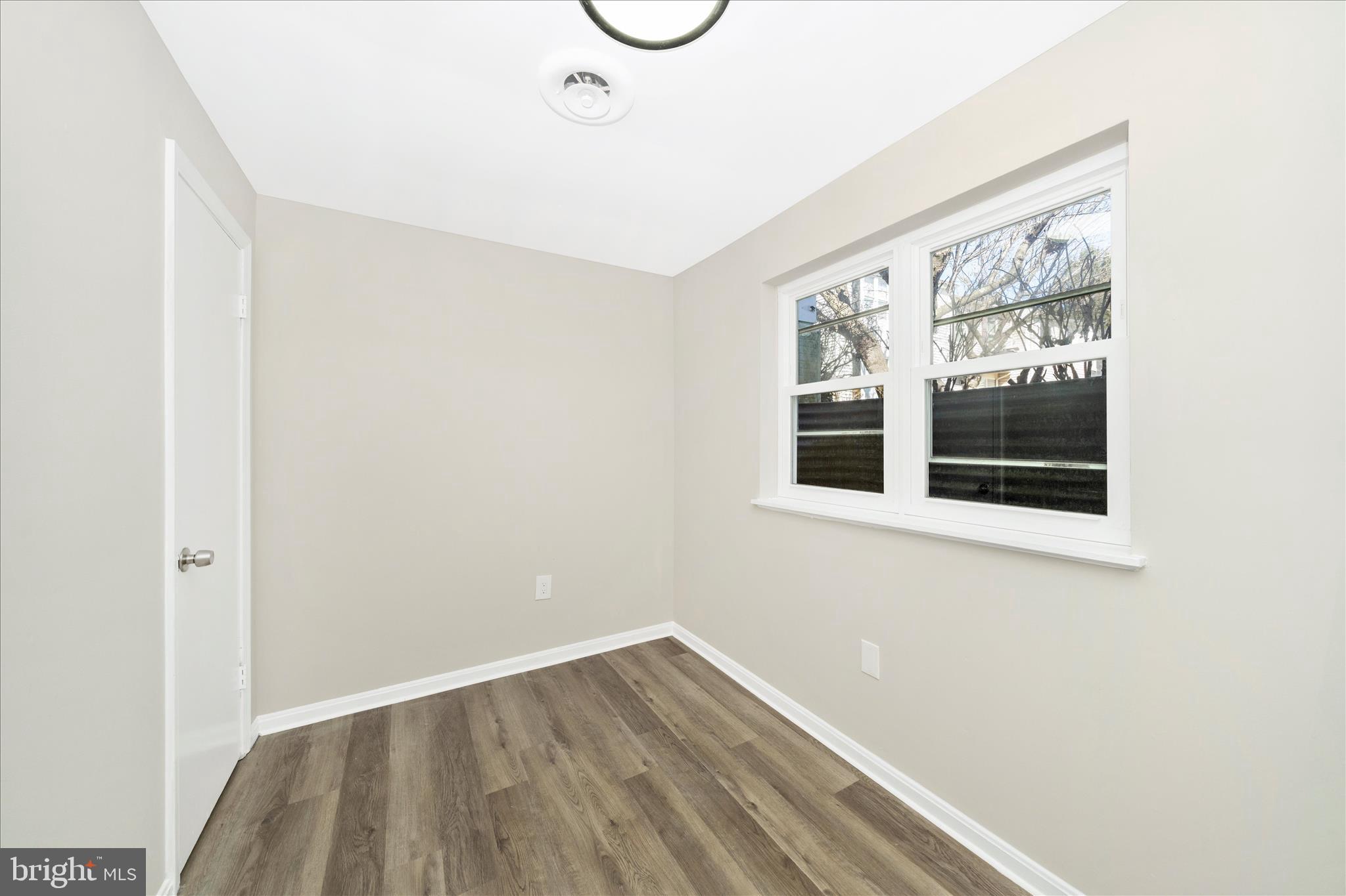 1848 Murdock Court Frederick, MD 21702 - Photo 36 of 54 a view of an empty room with wooden floor and windows