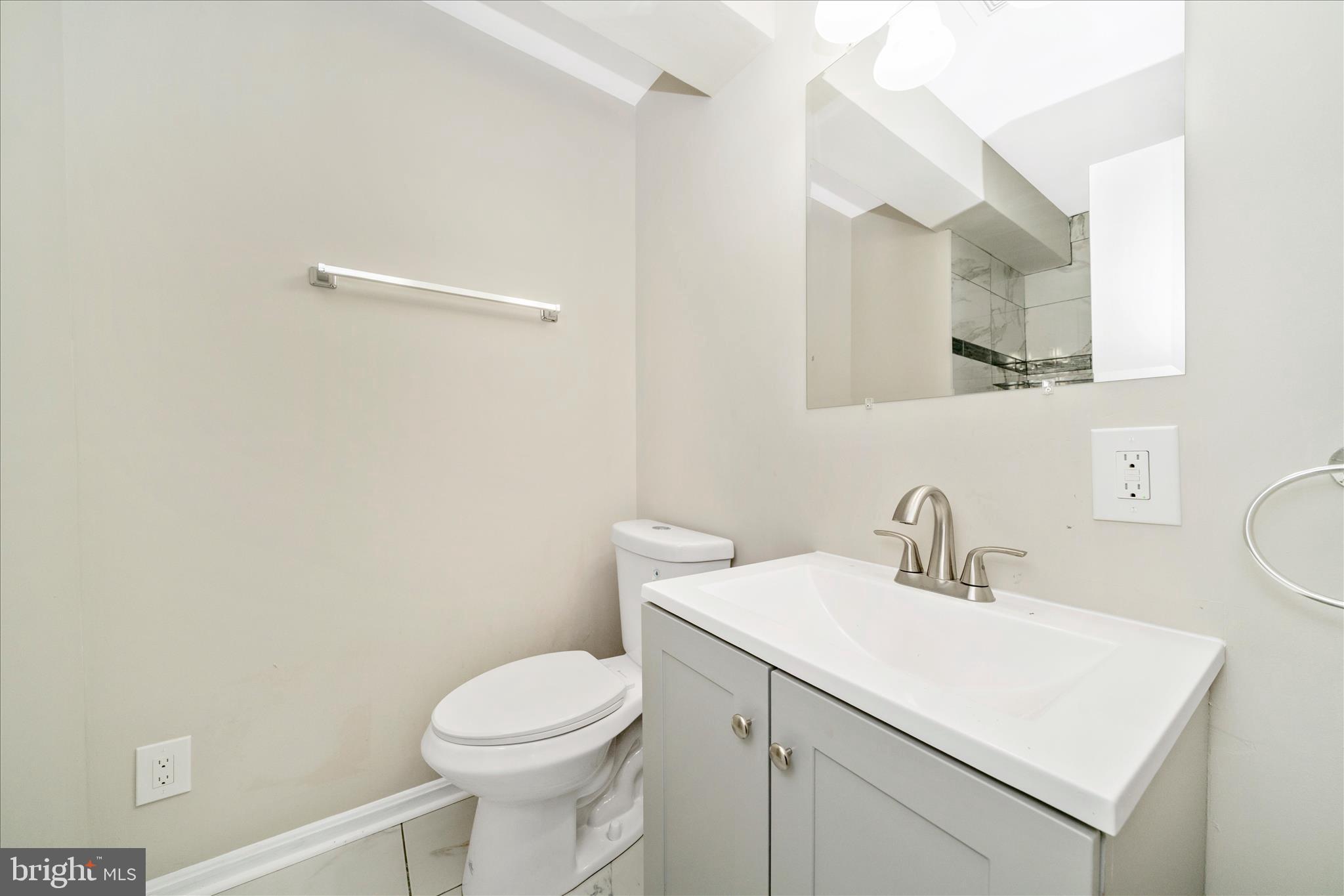1848 Murdock Court Frederick, MD 21702 - Photo 39 of 54 a bathroom with a toilet sink vanity and mirror