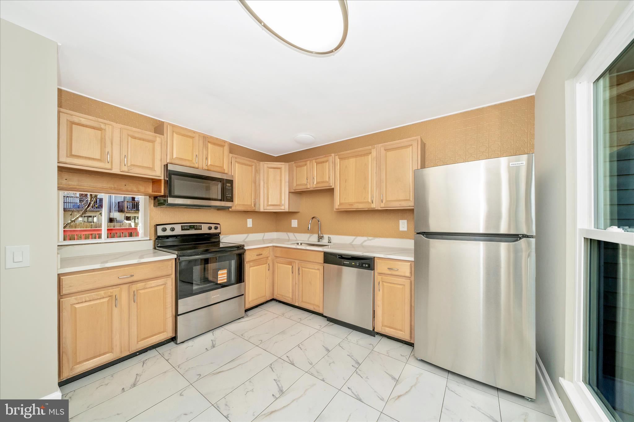 1848 Murdock Court Frederick, MD 21702 - Photo 5 of 54 a kitchen with cabinets stainless steel appliances and a window