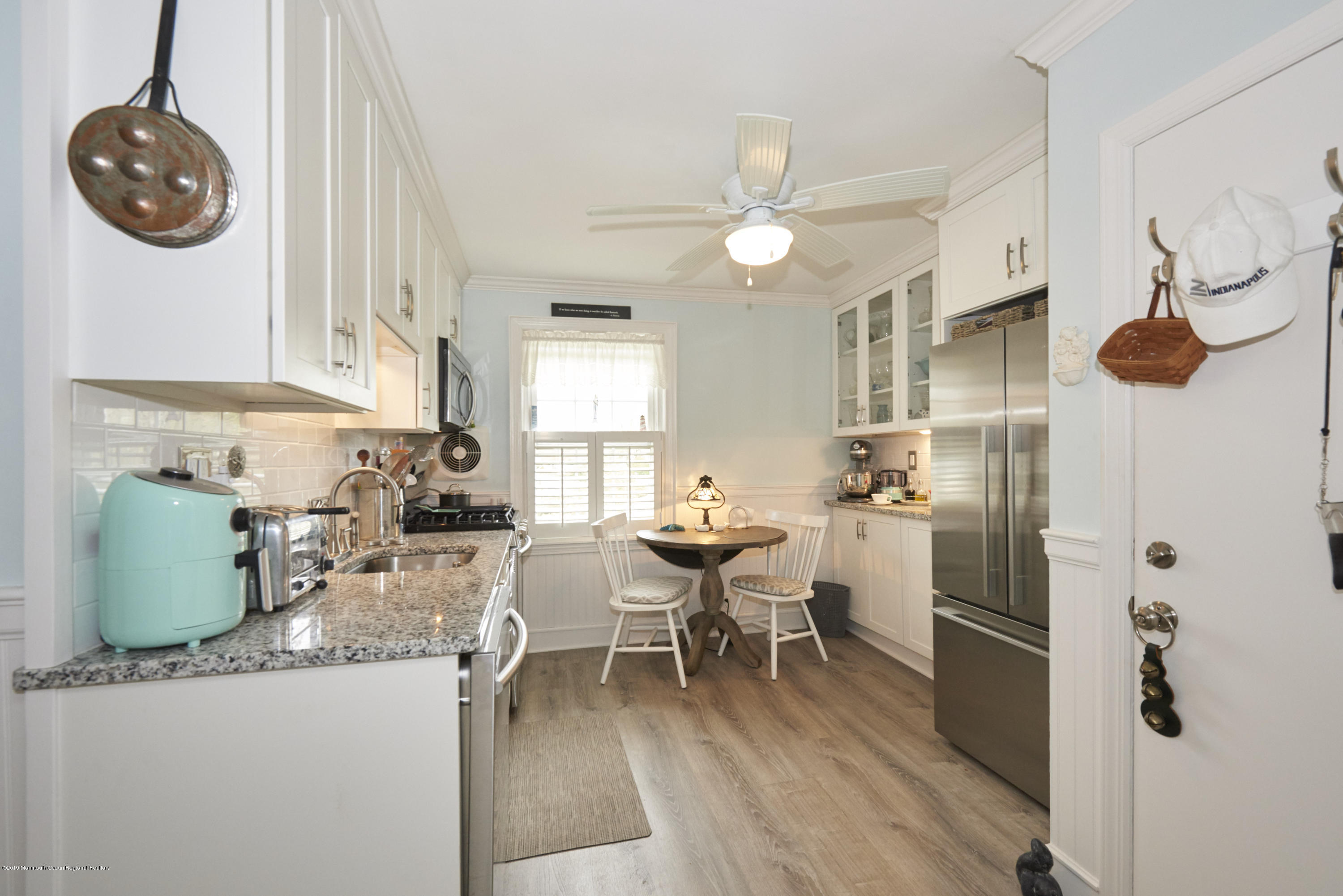 30 Pinckney Road, Unit C Red Bank, NJ 07701 - Photo 3 of 18 a kitchen with stainless steel appliances granite countertop a refrigerator a sink dishwasher a dining table and chairs with wooden floor