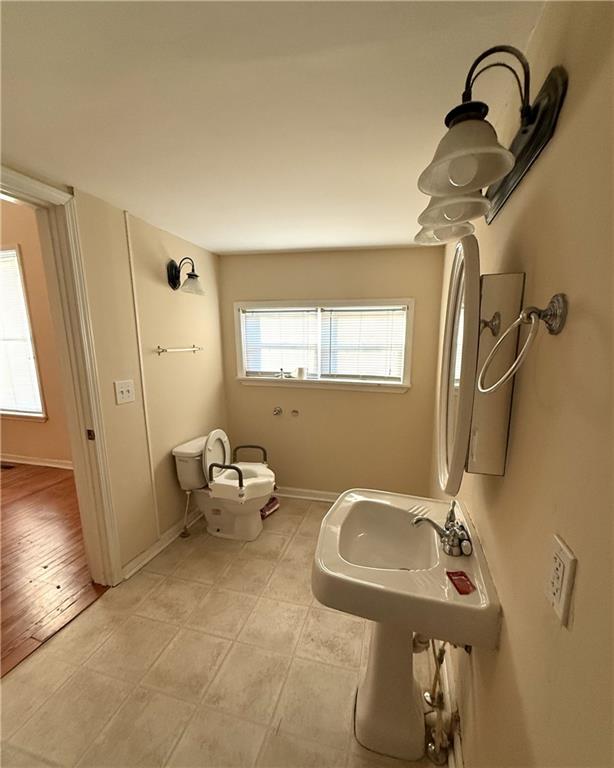 1740 Spring Street Northeast Conyers, GA 30012 - Photo 22 of 23 a bathroom with a sink mirror and a window