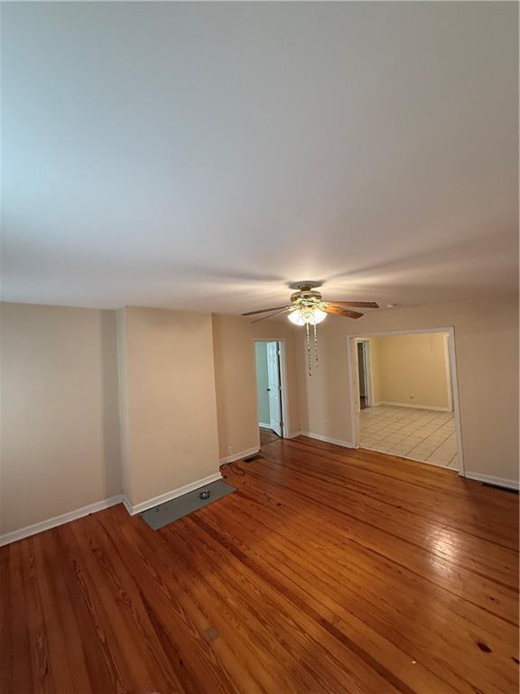 1740 Spring Street Northeast Conyers, GA 30012 - Photo 6 of 23 a view of an empty room with window and wooden floor