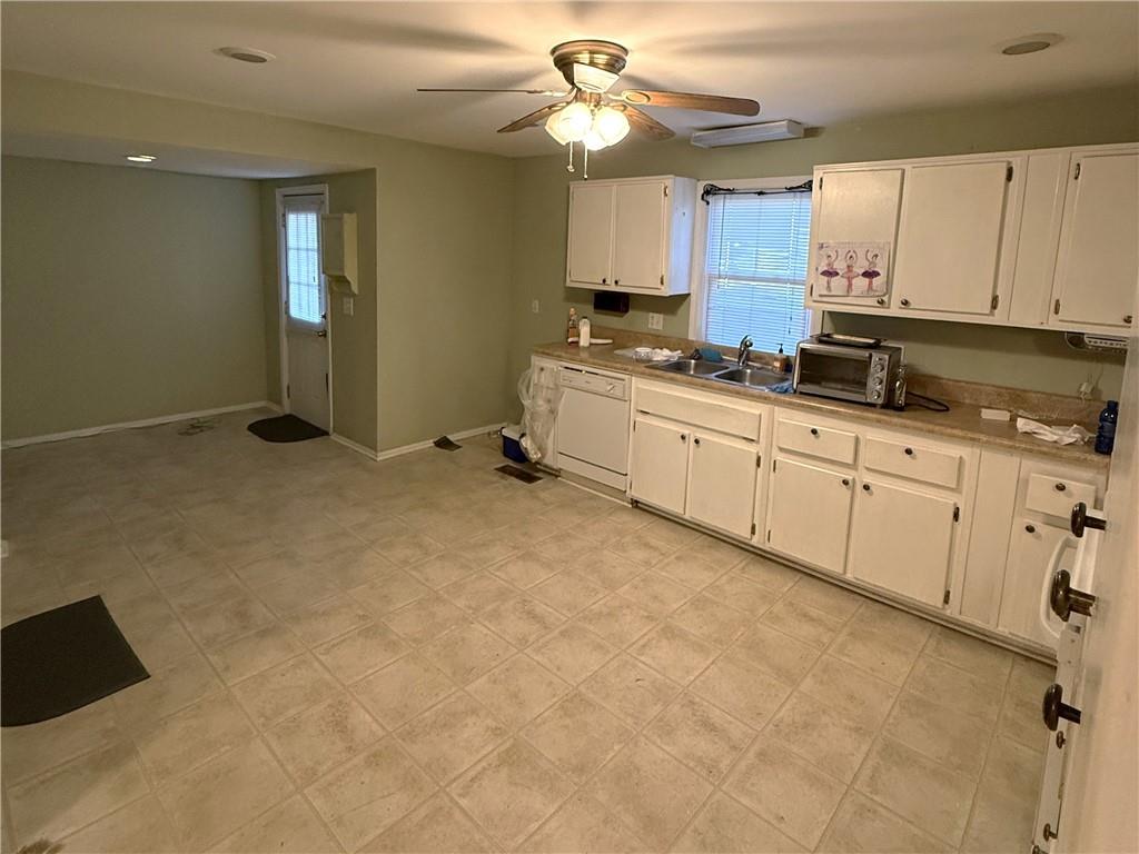 1740 Spring Street Northeast Conyers, GA 30012 - Photo 8 of 23 a kitchen with granite countertop a sink window and cabinets