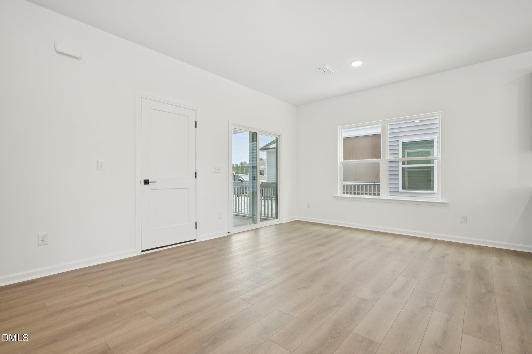 309 Marvel Drive, Unit 147 Rolesville, NC 27571 - Photo 14 of 39 wooden floor in an empty room with a window