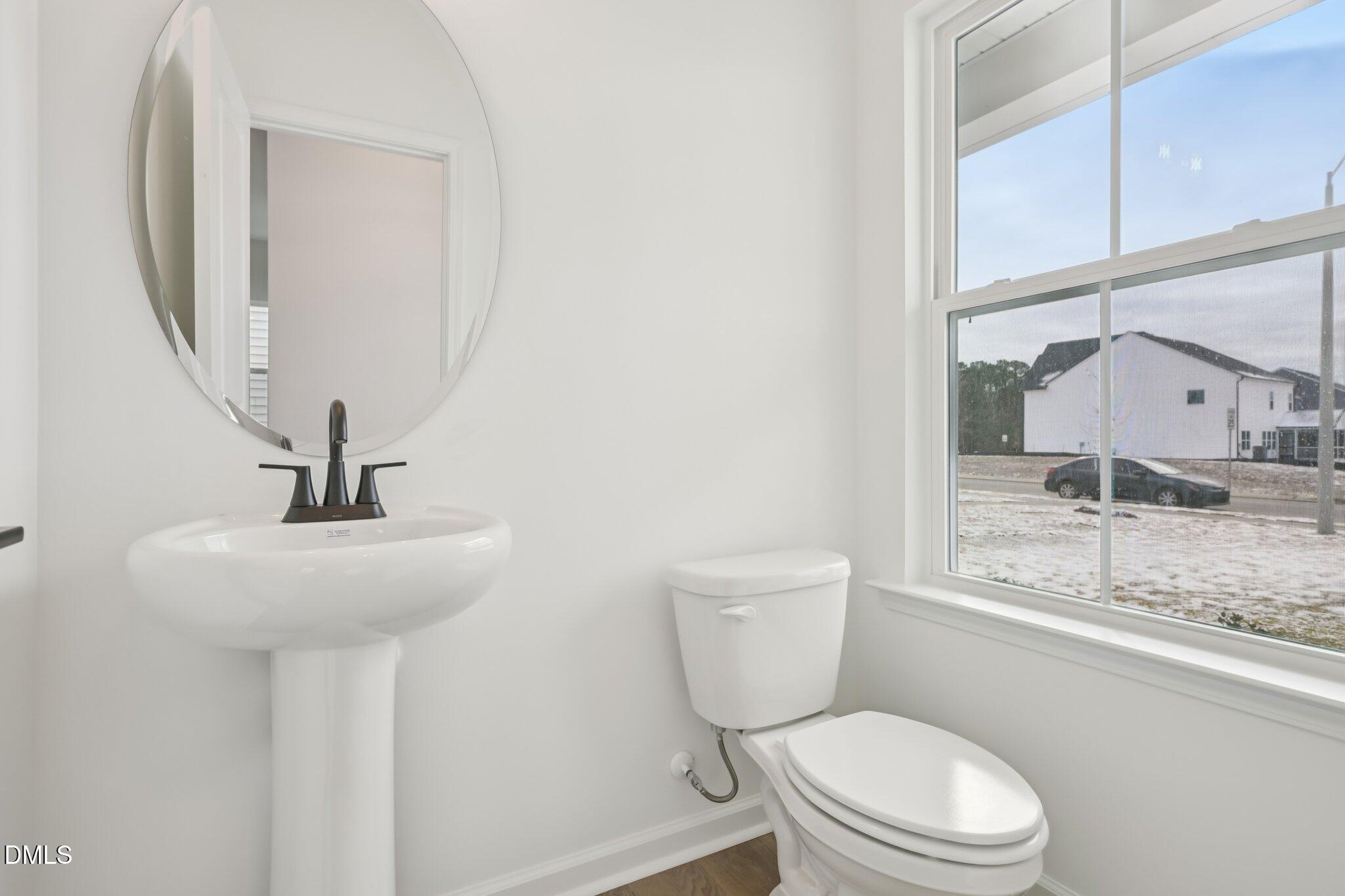 309 Marvel Drive, Unit 147 Rolesville, NC 27571 - Photo 15 of 39 a bathroom with a toilet a sink and mirror