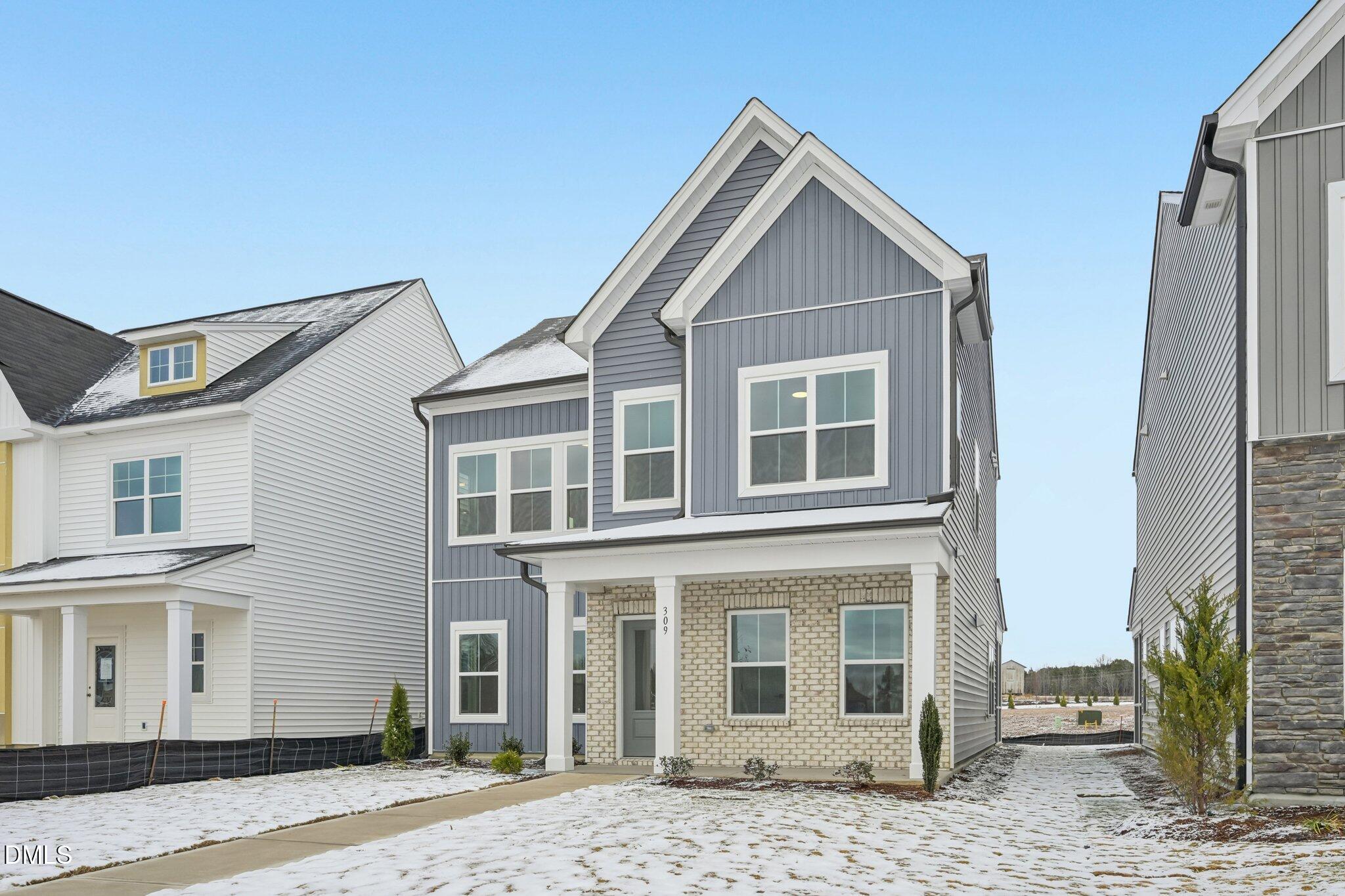 309 Marvel Drive, Unit 147 Rolesville, NC 27571 - Photo 3 of 39 a view of a brick house with many windows