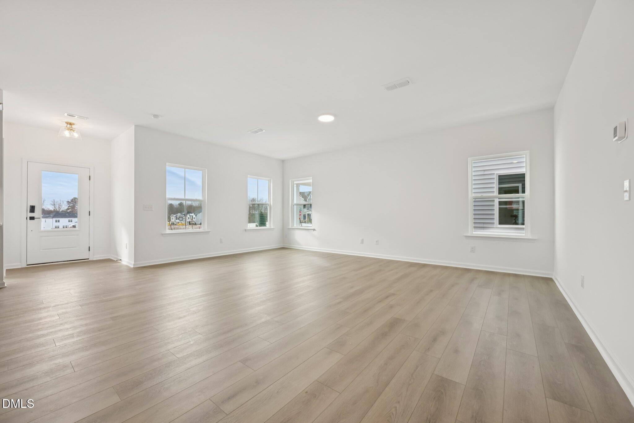 309 Marvel Drive, Unit 147 Rolesville, NC 27571 - Photo 6 of 39 wooden floor in an empty room with a window