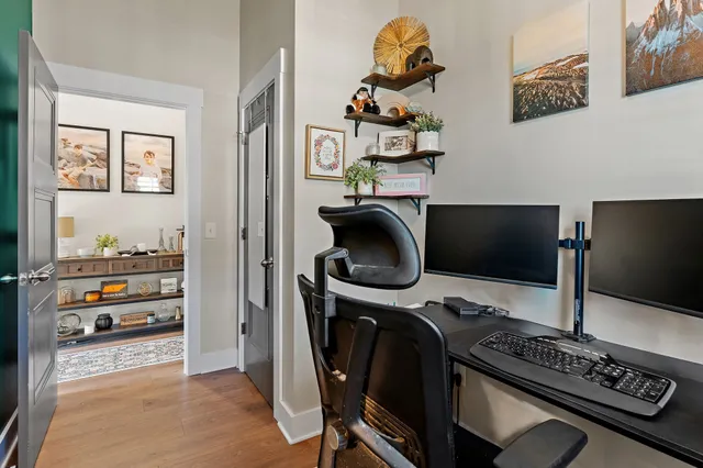 a view of a workspace with furniture and a flat screen tv
