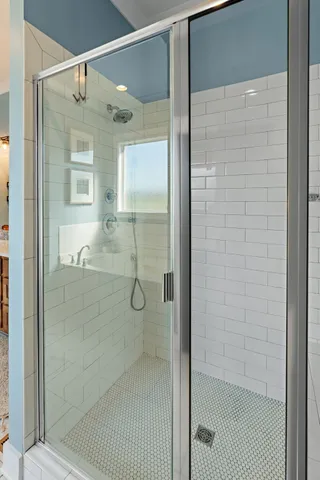 a bathroom with a glass shower door