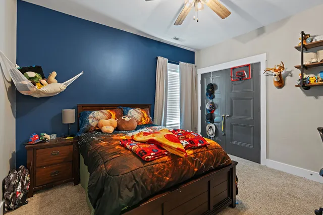 a bedroom with a bed and a chandelier