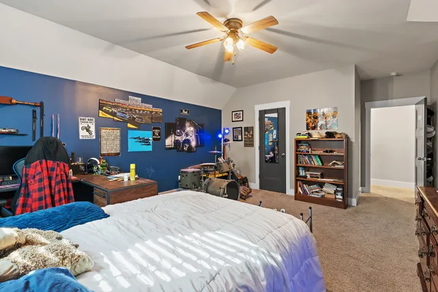 a bedroom with bed and a chandelier