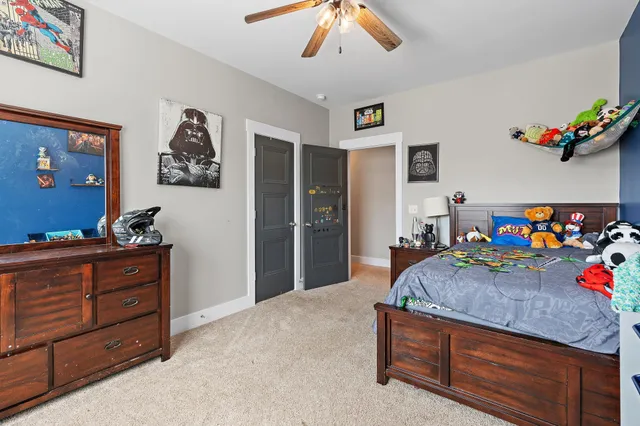 a bedroom with a bed and a dresser in it