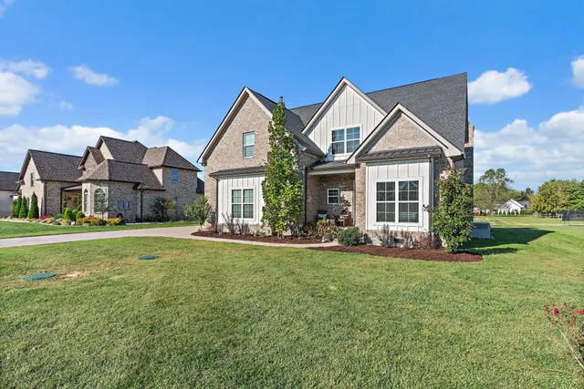 a front view of a house with a garden and porch