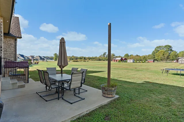 a view of a lake with table and chairs
