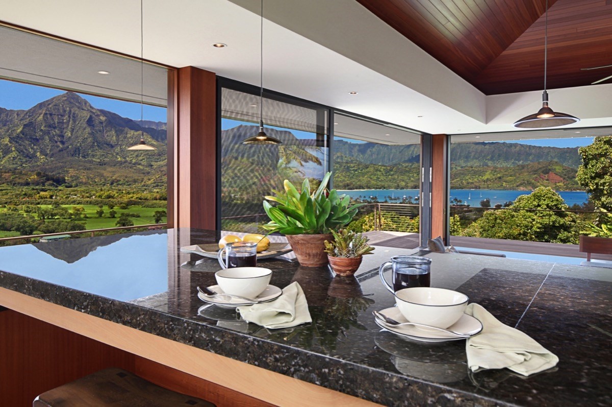 5181 Hanalei Plantation Road Princeville, HI 96722 - Photo 3 of 14 a table with a potted plant and a large window