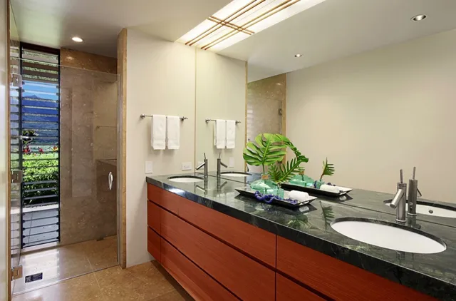 a bathroom with a granite countertop sink and a mirror