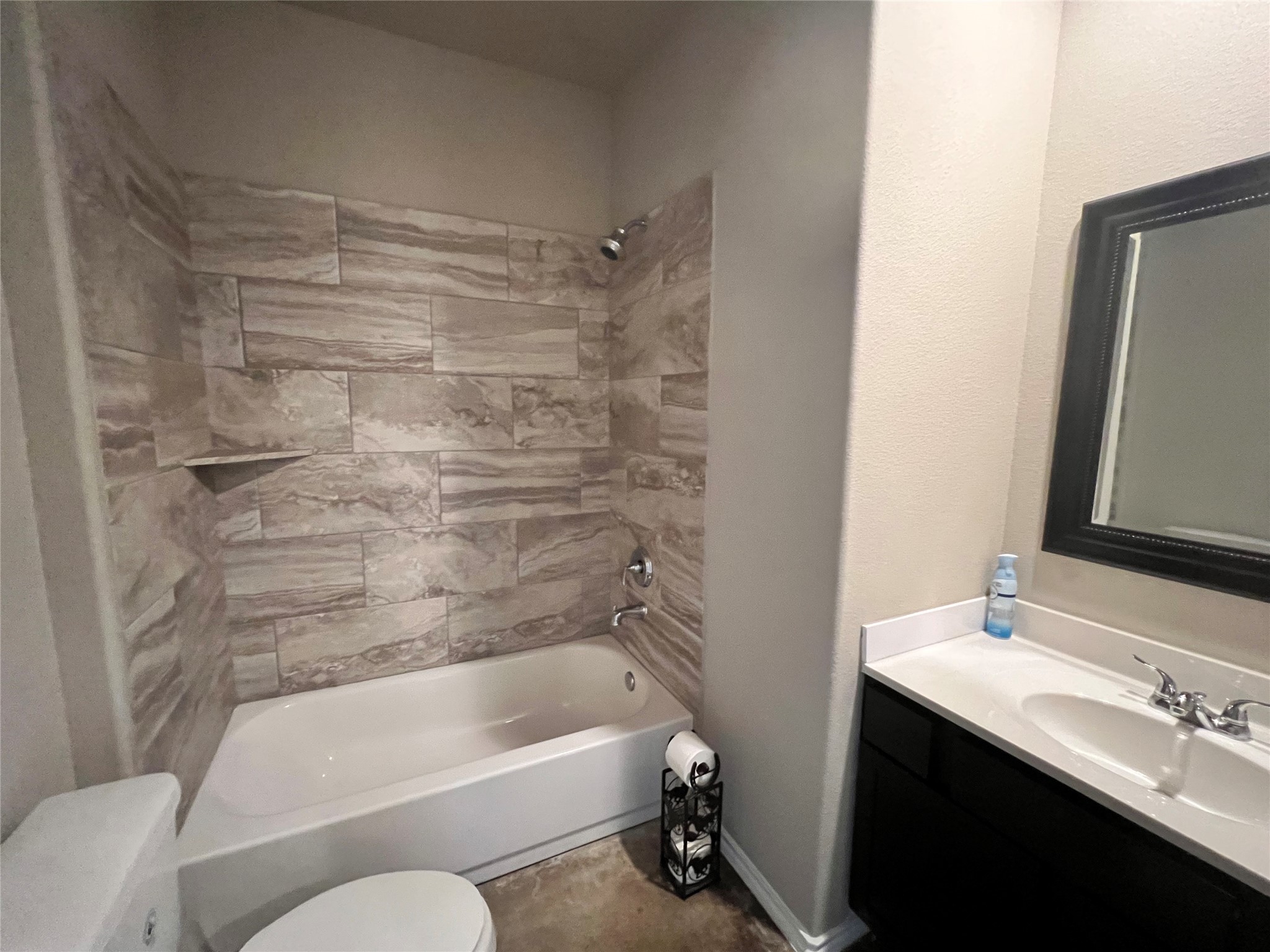 15887 Pecan Drive Montgomery, TX 77356 - Photo 6 of 11 a bathroom with a bathtub shower sink vanity and toilet