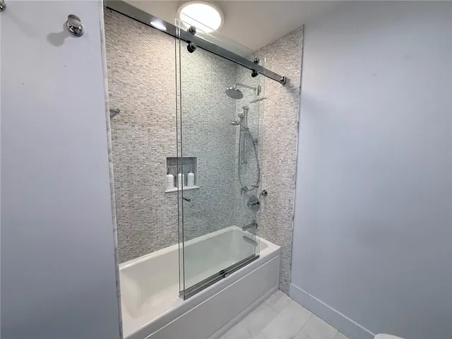 a bathroom with a glass shower door